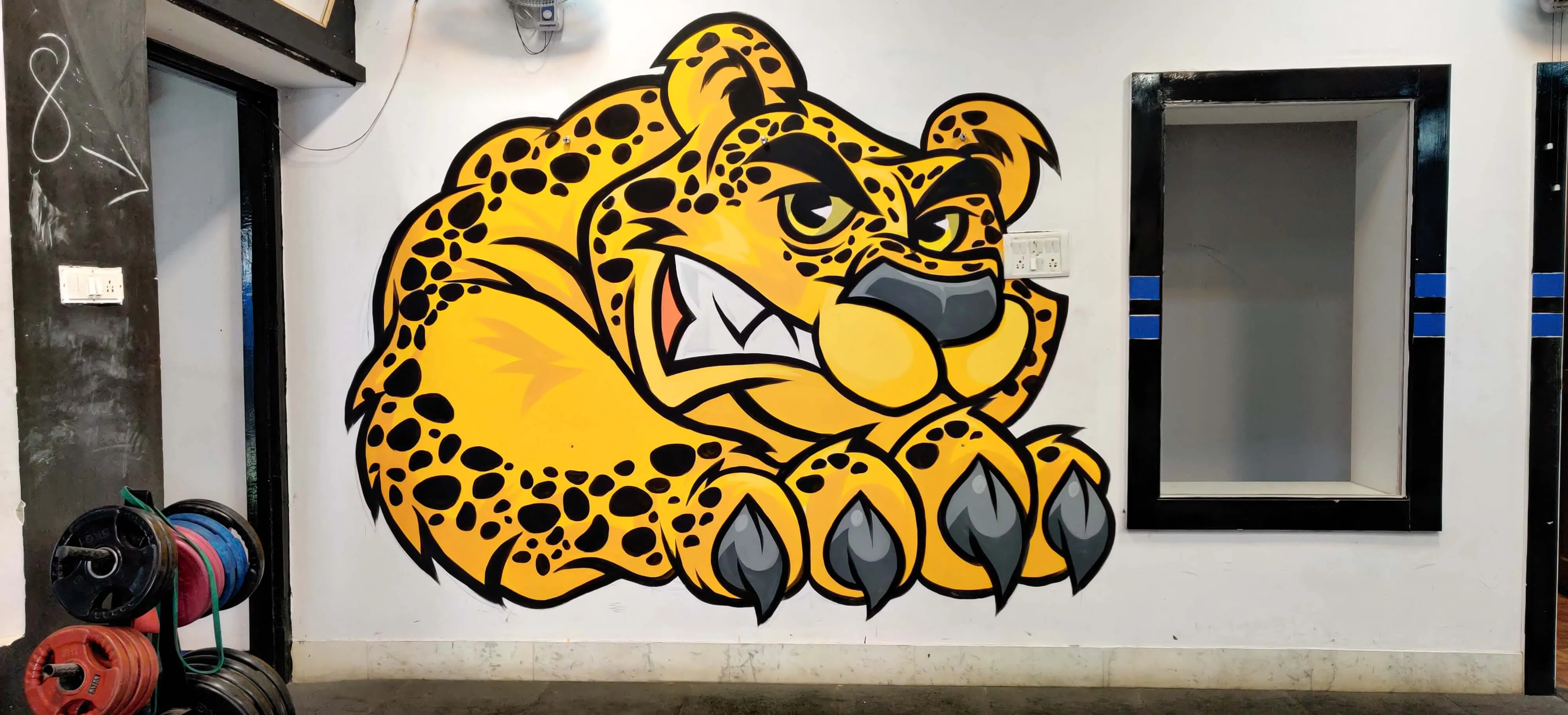 Mural of a cheetah's head on a white wall.